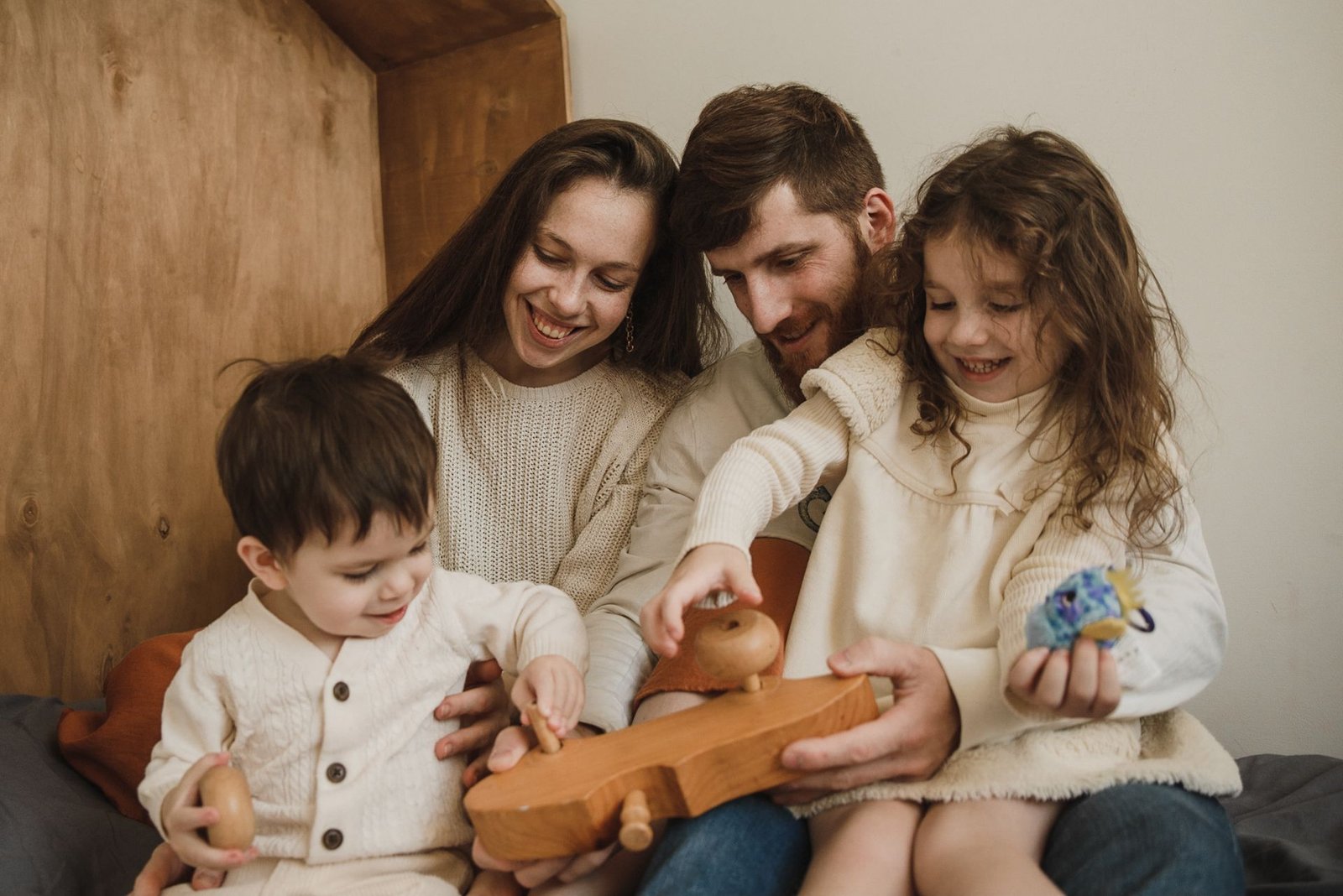 Parents playing with their kids at home, relaxed and present